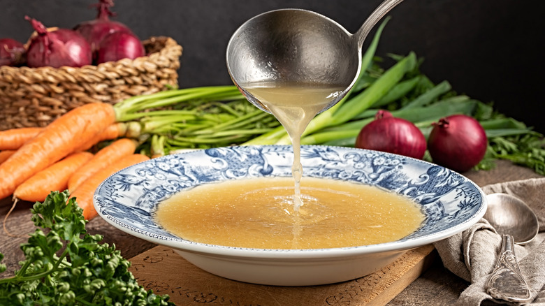 broth in bowl, ladle, vegetables