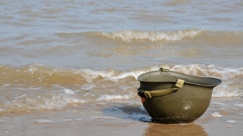 WWII helmet on shore of English Channel