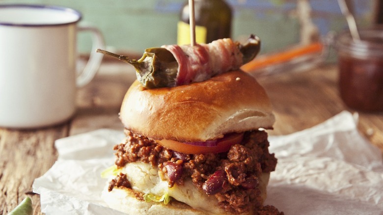 chili burger topped with jalapeño