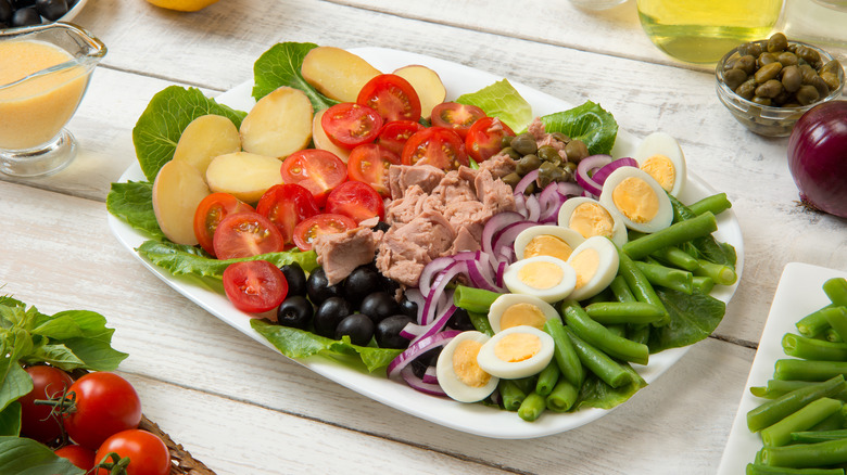 pan bagnat ingredients on white platter