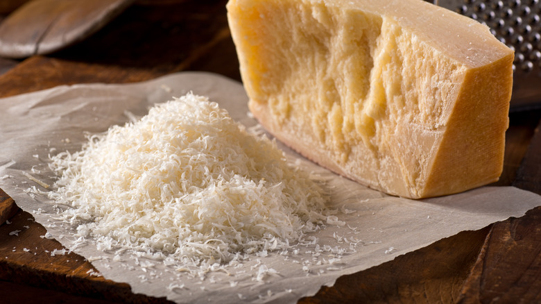 grated romano in front of block of cheese