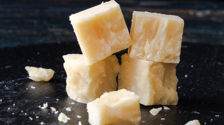 white cheddar cheese cubes on black table