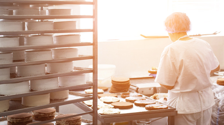 baker preparing cakes in commercial kitchen