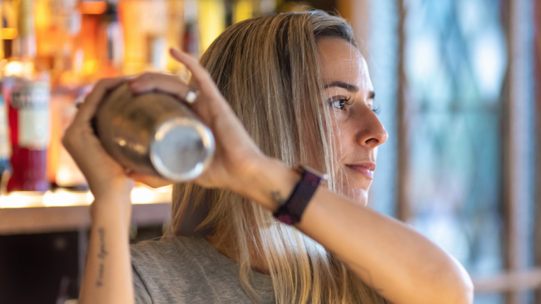 woman mixing cocktail