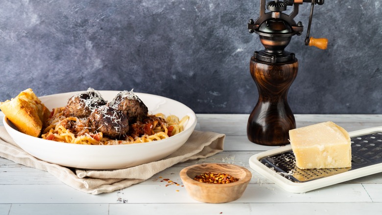 plate of meatballs next to block of cheese