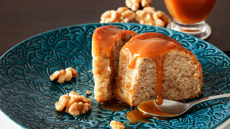 A slice of banana bread with caramel sauce on plate