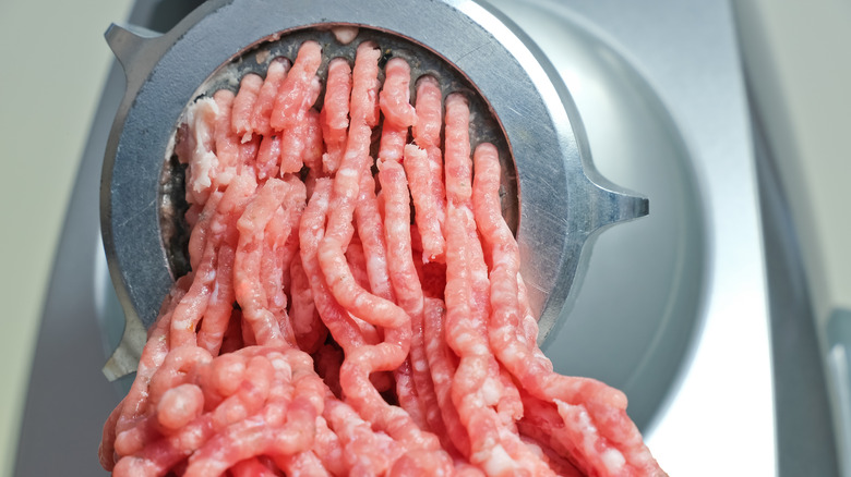 Ground beef exiting a meat grinder