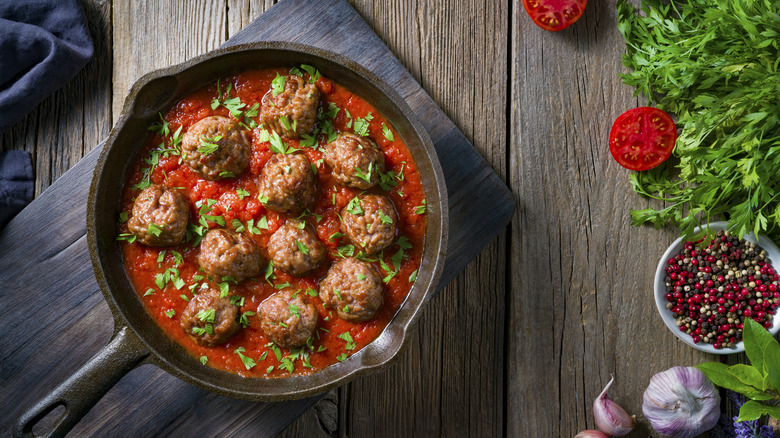 Meatballs in tomato sauce in a cast iron skillet