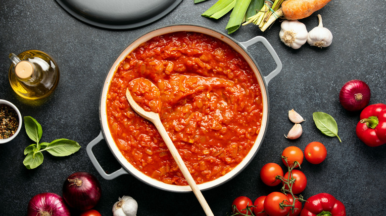 Tomato sauce pot with spoon