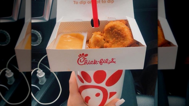 Chick-fil-A nuggets box balancing on a drink hack