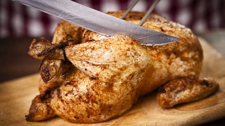 Carving a roasted chicken