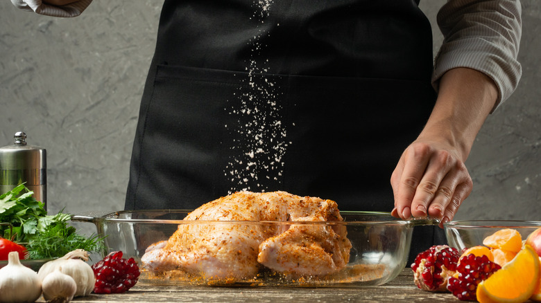 Seasoning a raw chicken