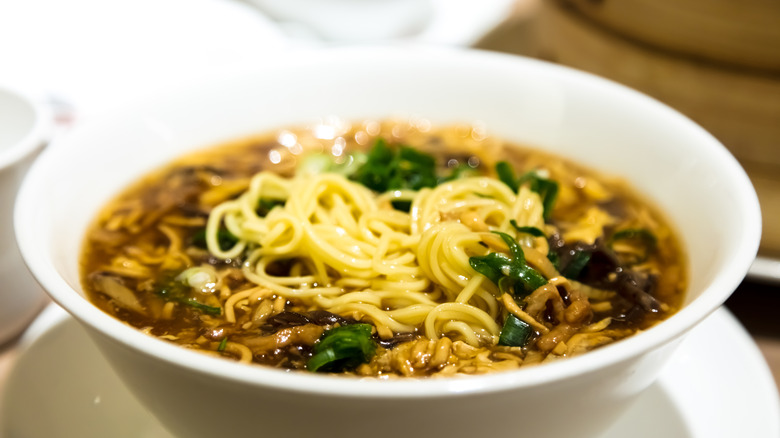 Ramen and black vinegar sauce in a white bowl