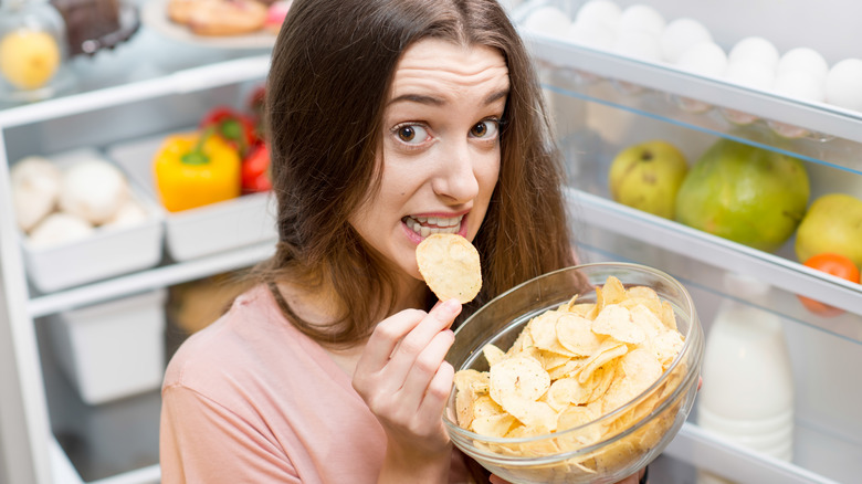 woman eating potato chips