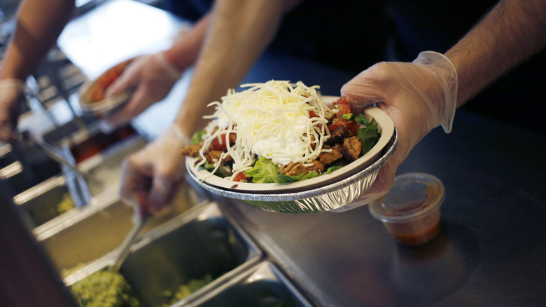 assembling Chipotle burrito bowl