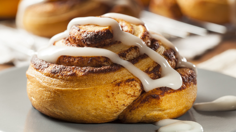 Plated cinnamon roll with drizzle of icing