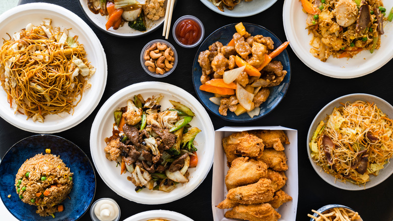 Overhead shot of table full of Chinese food dishes.