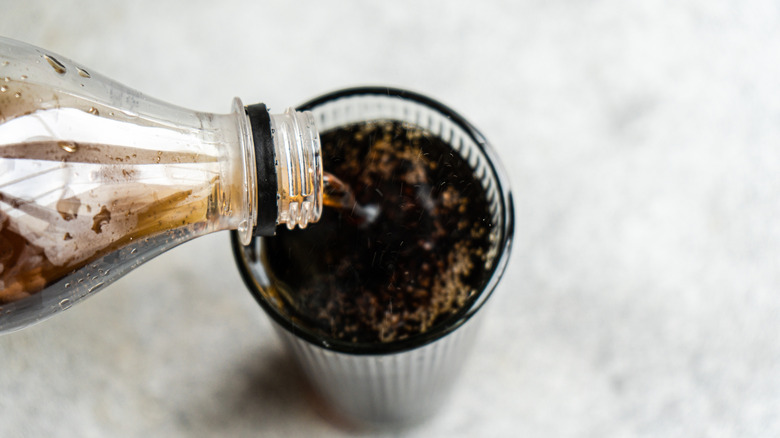 Pouring a glass of cola