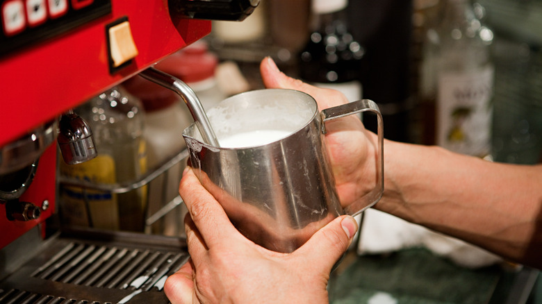 Barista preparing drink at coffee shop