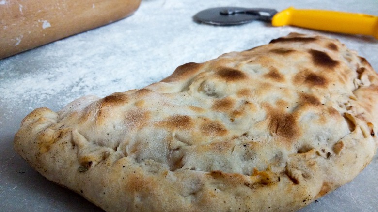 Calzone with pizza cutter