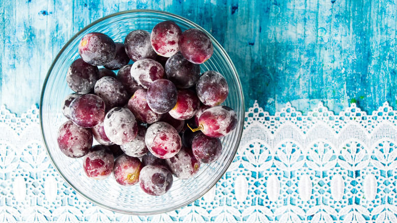 frozen grapes in bowl on blue table