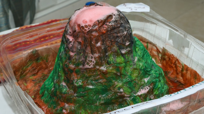 An erupting science fair volcano in a plastic tub