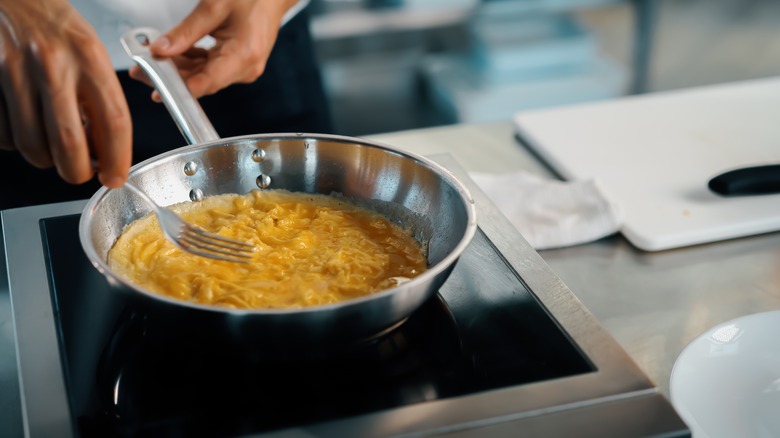 cooking scrambled eggs in a pan