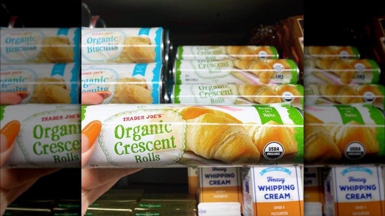 A person holding a tube of trader joe's organic crescent rolls