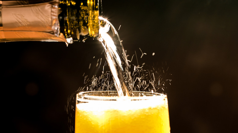 Pouring champagne into orange juice