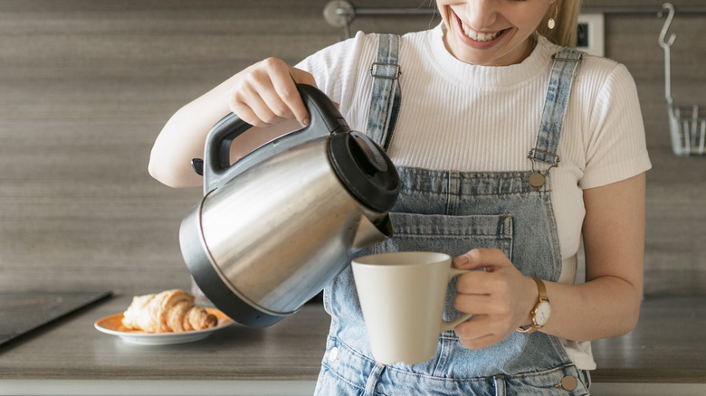 woman pouring coffee from a carafe