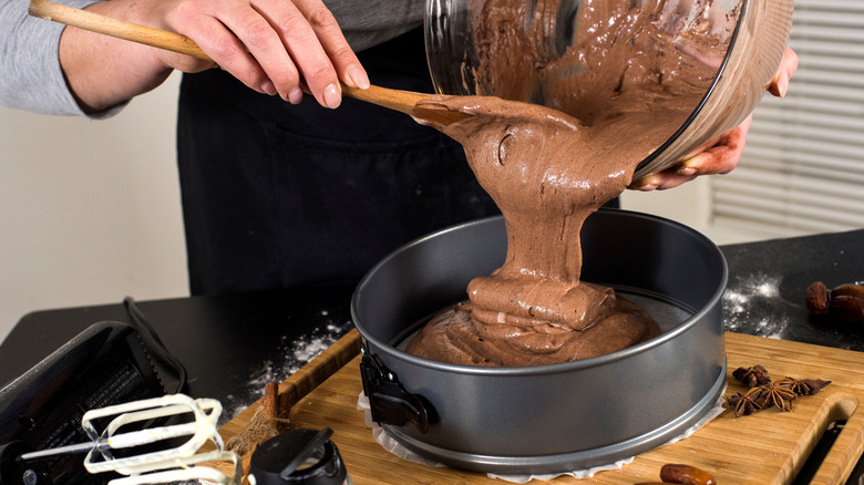 pouring cake batter into pan