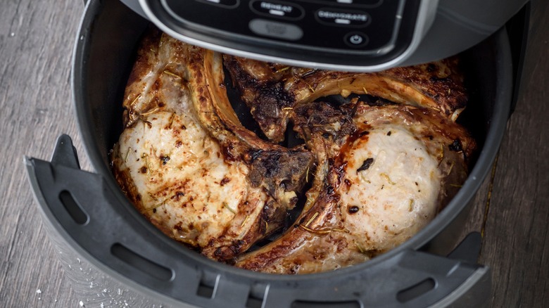 pork chops being cooked in air fryer