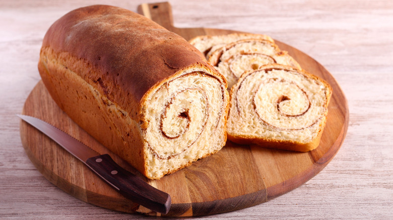 Cinnamon swirl bread on wooden chopping board