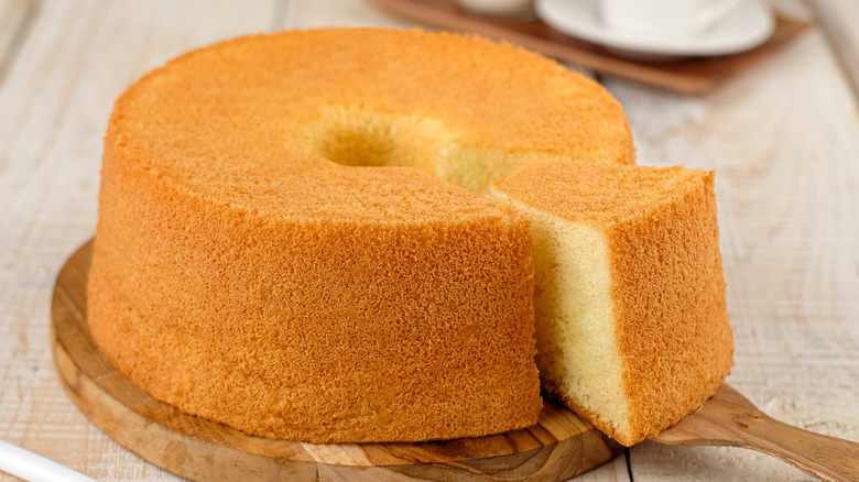 Partially sliced chiffon cake on board