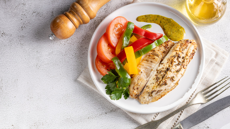 Tilapia on plate with vegetables