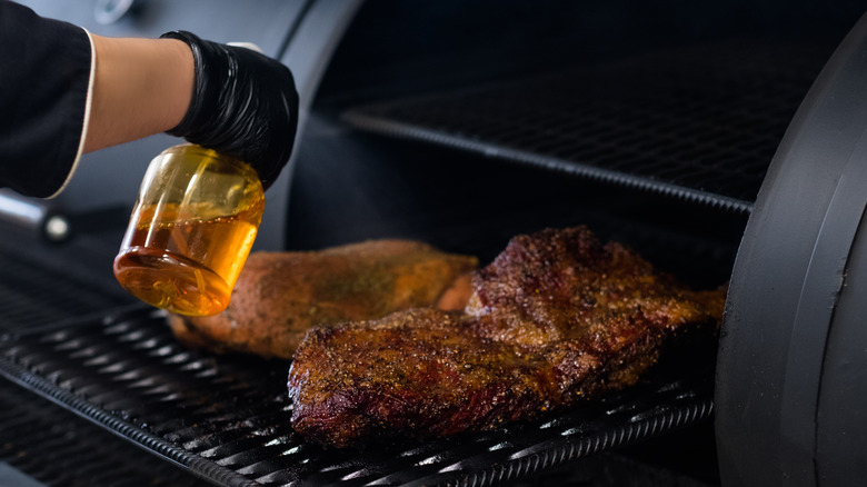 Cook spraying brisket