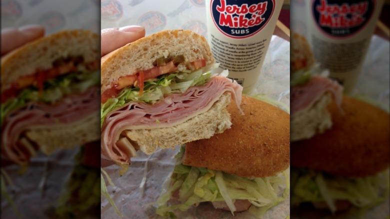 holding half of a sub sandwich