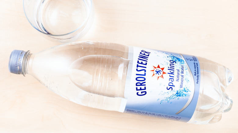A glass and bottle of Gerolsteiner sparkling water