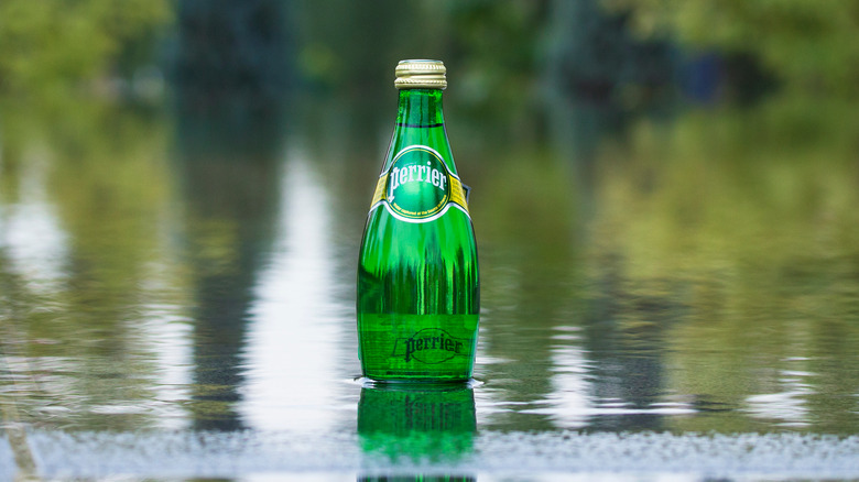 A bottle of Perrier sparkling water in river