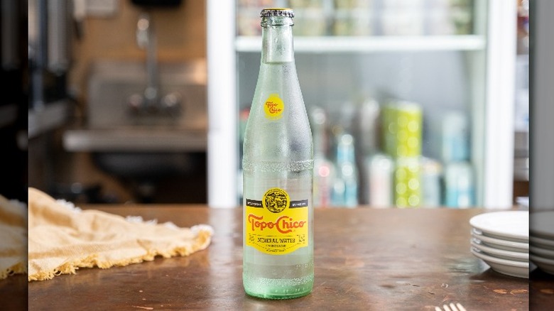 A bottle of Topo Chico on a table