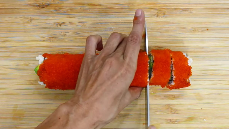 Boston sushi roll being sliced