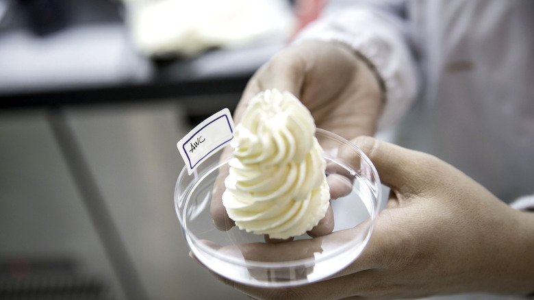 lab technician holding cream cheese