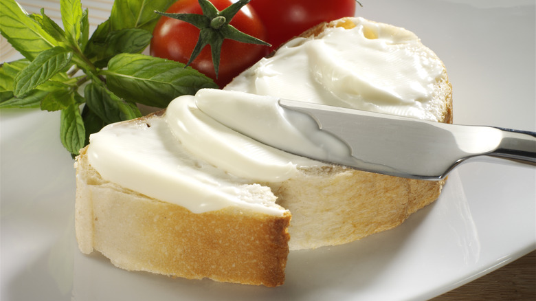 spreading cream cheese