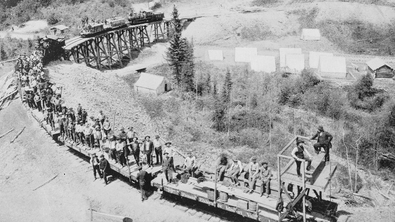 Railroad workers packed onto bridge