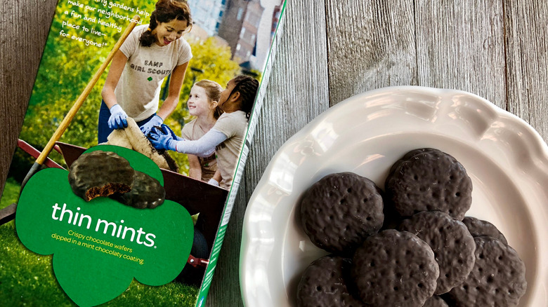 Box of Girl Scout Thin Mint cookies next to a plate of cookies