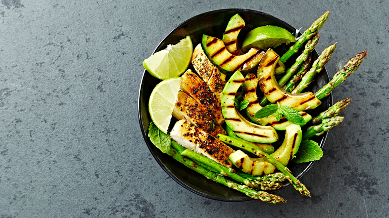 Bowl of chicken, asparagus, and grilled avocado