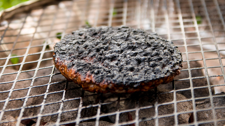 Burnt hamburger on a grill 