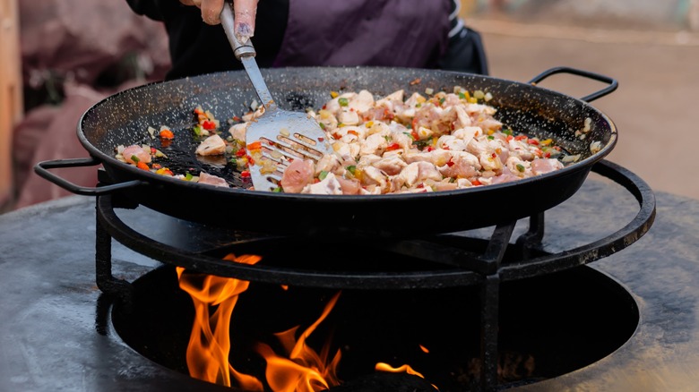 Paella ingredients in large wok