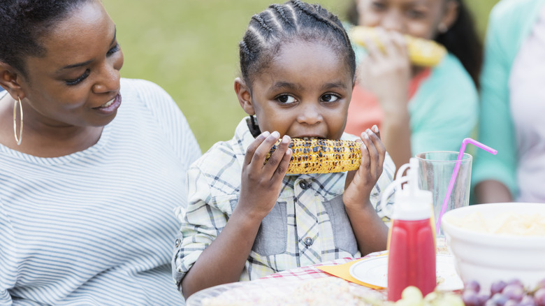 child eats corn on the cob