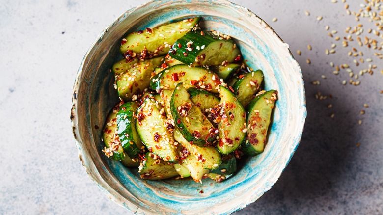 Smacked cucumber salad in a blue bowl